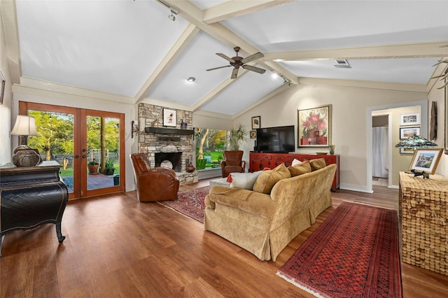 living room with hardwood / wood-style floors, ceiling fan, a fireplace, lofted ceiling with beams, and french doors