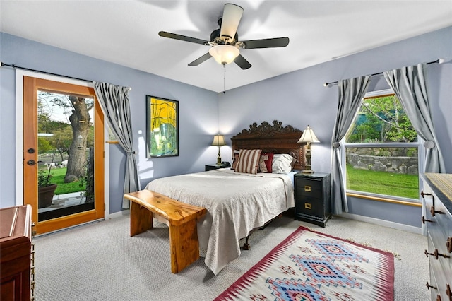 carpeted bedroom with ceiling fan and access to exterior