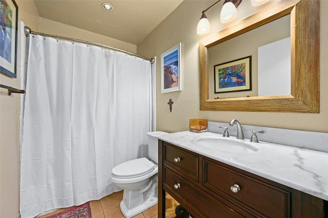 bathroom featuring vanity, tile floors, and toilet