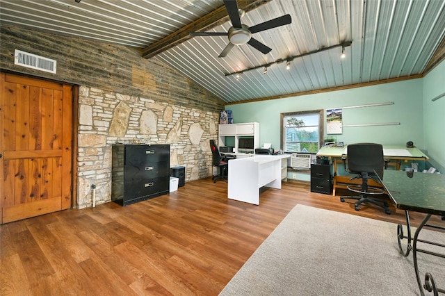 office featuring a fireplace, ceiling fan, light wood-type flooring, and track lighting