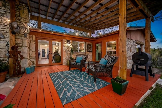 wooden deck with a grill and french doors