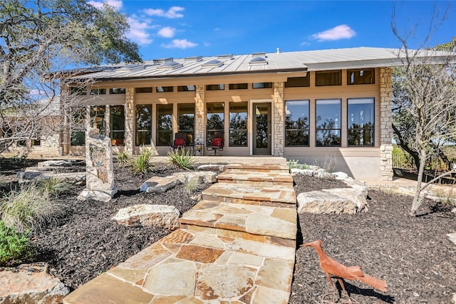 back of house featuring metal roof and a standing seam roof