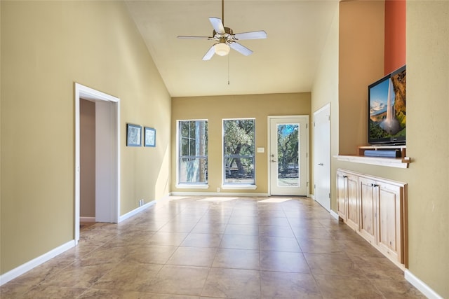 unfurnished living room with high vaulted ceiling, ceiling fan, and light tile patterned floors