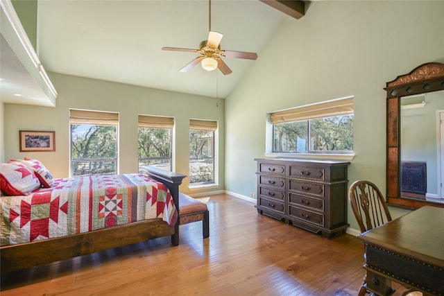 bedroom with ceiling fan, beamed ceiling, light hardwood / wood-style flooring, and high vaulted ceiling