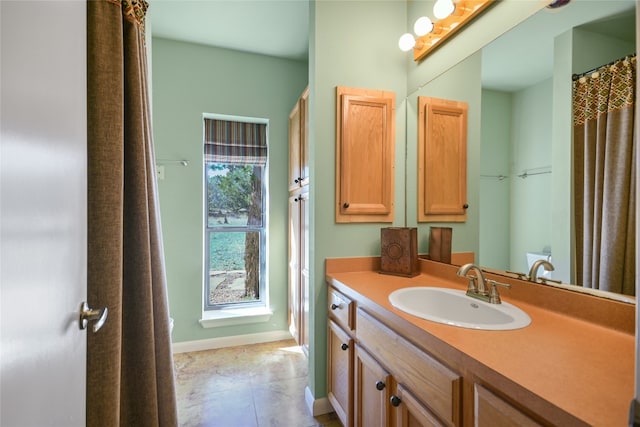 bathroom featuring tile patterned flooring and vanity