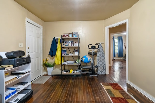 exercise room with dark hardwood / wood-style floors