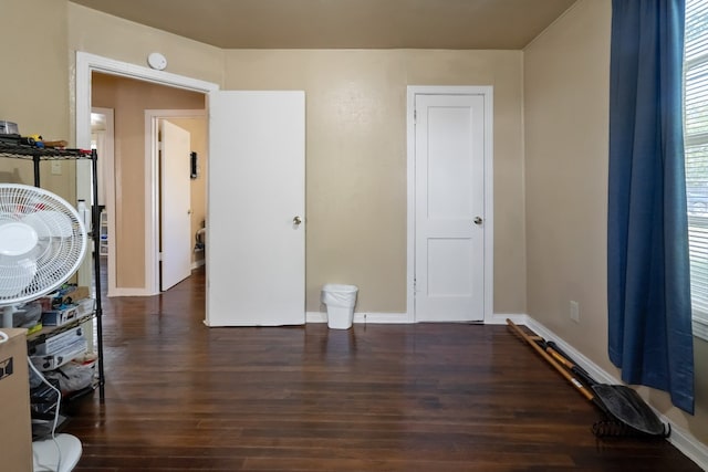 bedroom with dark wood-type flooring