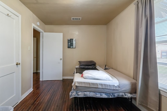 bedroom with dark wood-type flooring