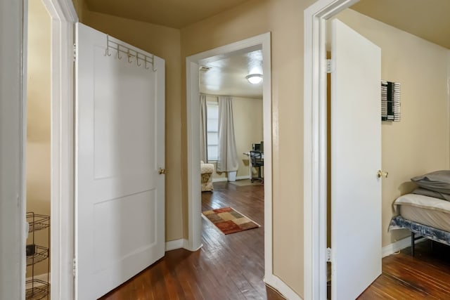 corridor featuring dark wood-type flooring