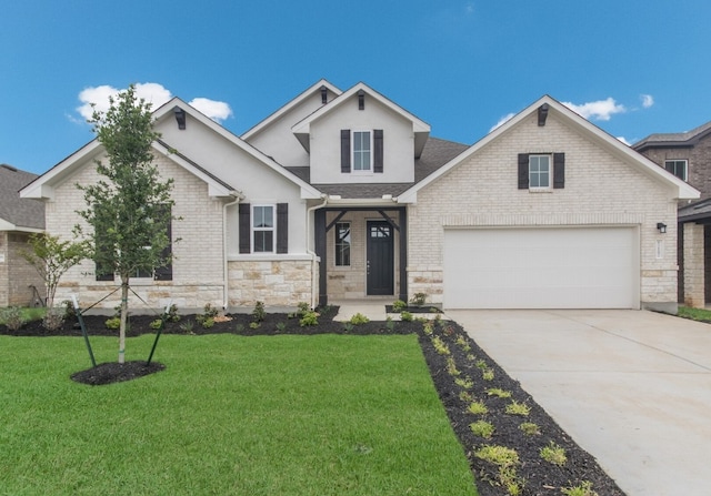 view of front facade featuring a front yard and a garage