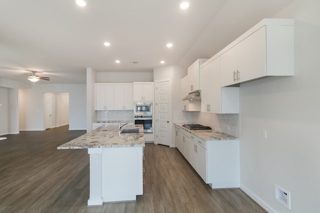 kitchen with white cabinets, tasteful backsplash, ceiling fan, and dark hardwood / wood-style floors