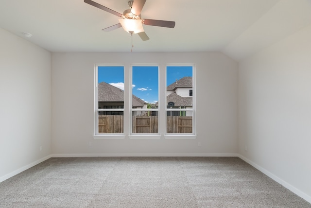 spare room with lofted ceiling, light colored carpet, and ceiling fan