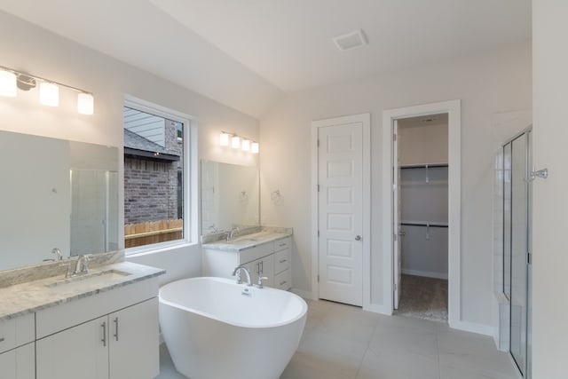 bathroom with independent shower and bath, tile floors, and dual bowl vanity