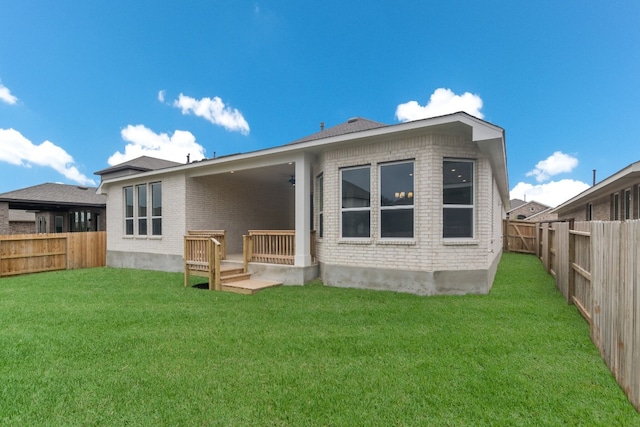 rear view of property with a lawn