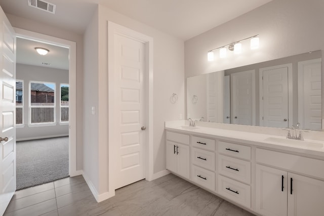 bathroom with double sink vanity and tile flooring