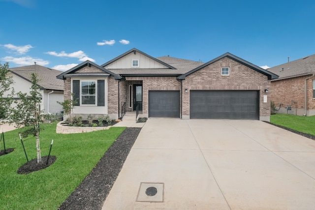 view of front of property with a front yard and a garage