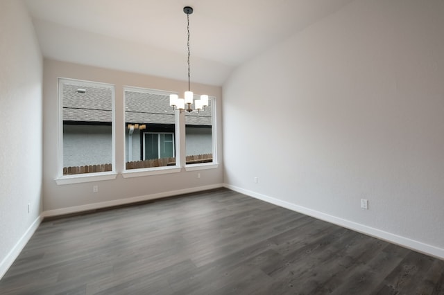 unfurnished room featuring a chandelier, vaulted ceiling, and dark hardwood / wood-style flooring