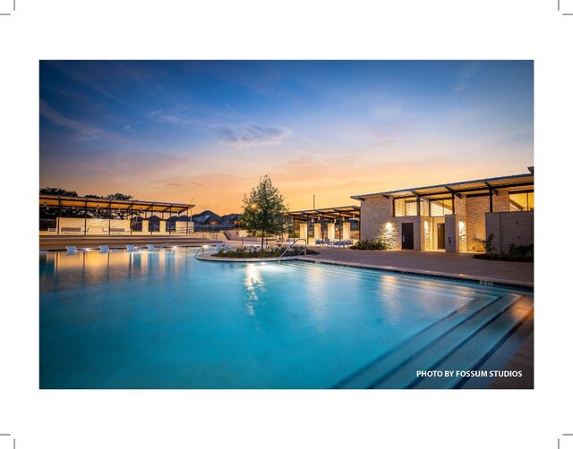 view of pool at dusk