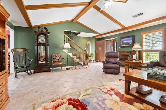 living room featuring lofted ceiling with beams, light tile patterned flooring, and ceiling fan