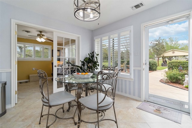 dining space featuring light tile patterned flooring and ceiling fan