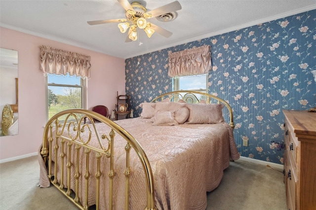 carpeted bedroom with a textured ceiling, ornamental molding, and ceiling fan