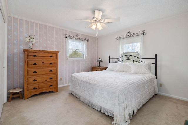 carpeted bedroom with multiple windows, crown molding, and ceiling fan