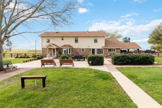 rear view of house featuring fence, a yard, a patio area, and brick siding