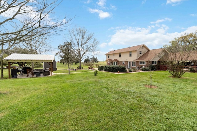 view of yard with a gazebo, an outdoor hangout area, and a patio area