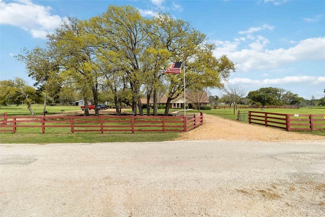 view of home's community featuring a rural view and a yard