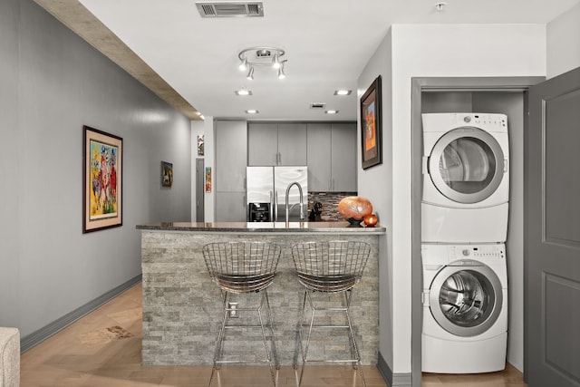 washroom with stacked washer / drying machine