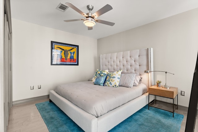 bedroom with light hardwood / wood-style floors and ceiling fan