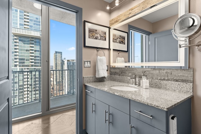 bathroom with tile flooring, vanity, and a wealth of natural light