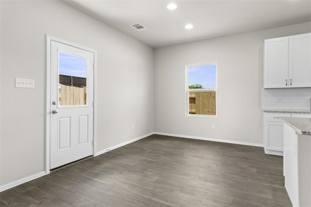 unfurnished dining area with dark hardwood / wood-style floors