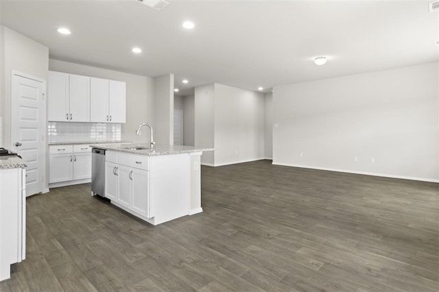 kitchen featuring white cabinets, decorative backsplash, dishwasher, and an island with sink