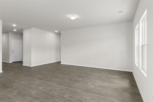 spare room with dark hardwood / wood-style floors