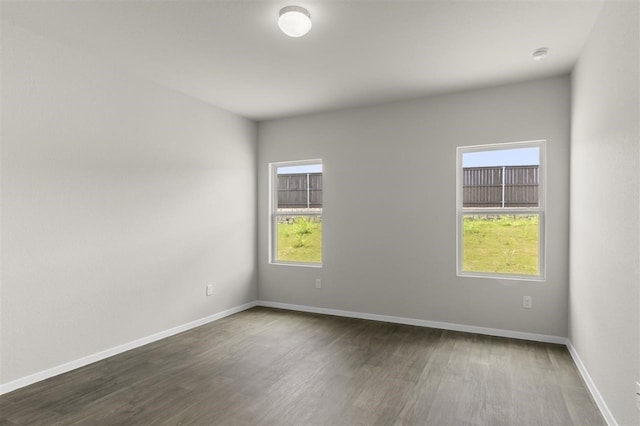 spare room featuring dark hardwood / wood-style flooring