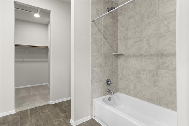 bathroom with tiled shower / bath combo and hardwood / wood-style floors