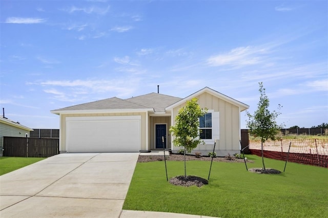 single story home featuring a front lawn and a garage