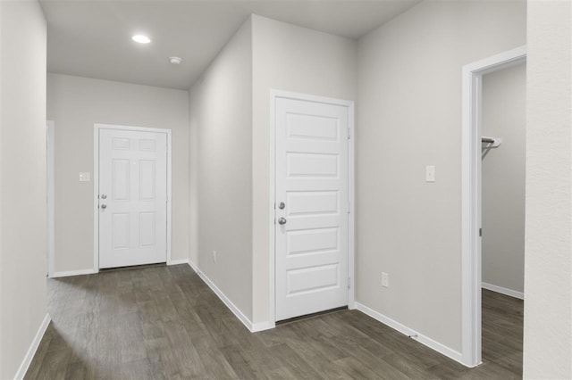 corridor with dark hardwood / wood-style floors