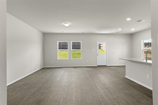 unfurnished living room with dark hardwood / wood-style flooring