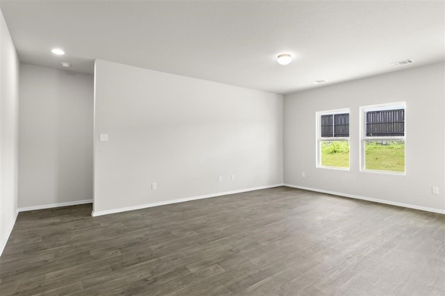 empty room with dark hardwood / wood-style floors