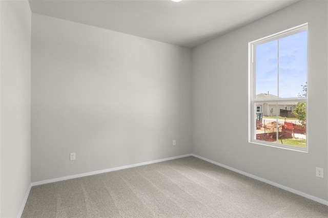 unfurnished room featuring carpet floors and plenty of natural light