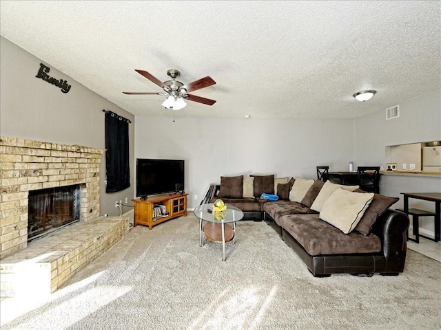 7825 Beauregard Cir Unit 5, Austin, TX 78745 - carpeted living area with ceiling fan, a fireplace, and a textured ceiling