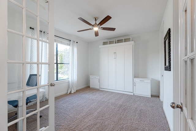 bedroom with ceiling fan, light carpet, and french doors