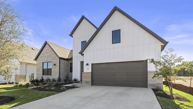 modern farmhouse style home with a garage and a front lawn