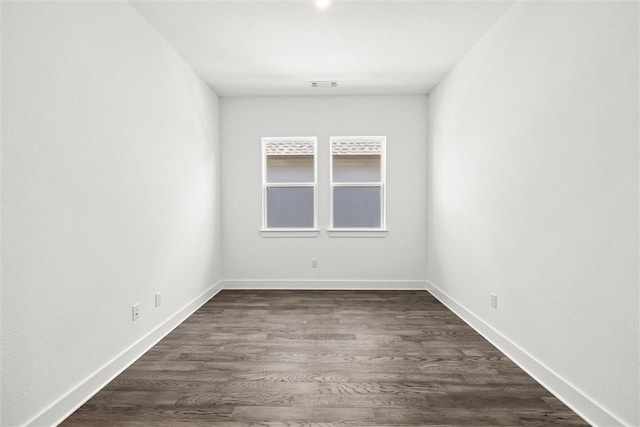 spare room featuring dark wood-type flooring