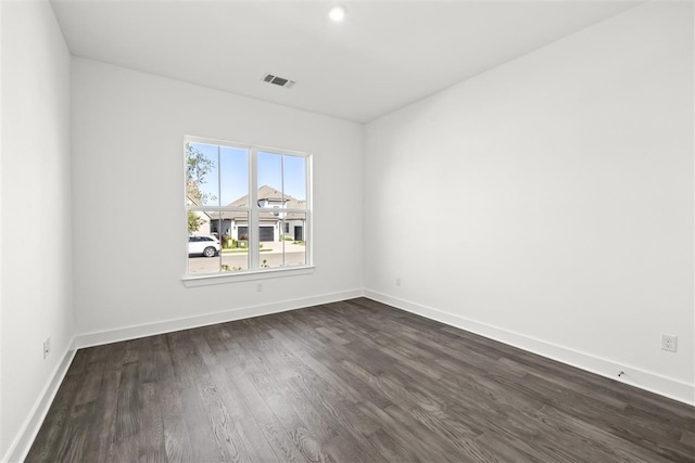 spare room featuring dark wood-type flooring