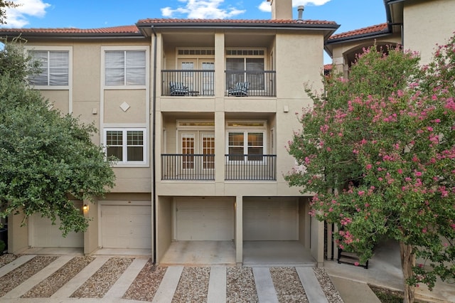 view of front facade with a balcony and a garage