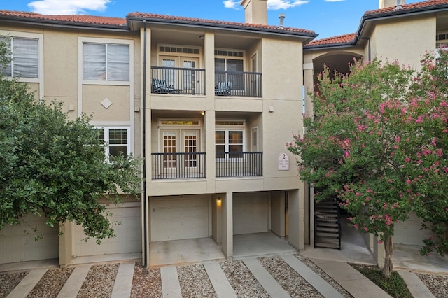 exterior space with a balcony and a garage