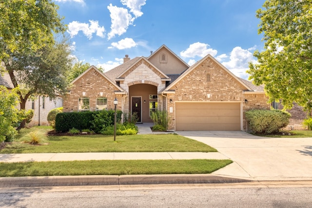 view of front facade featuring a garage, brick siding, driveway, a chimney, and a front yard